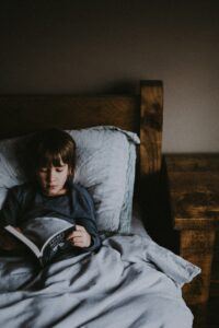 boy reading in bed